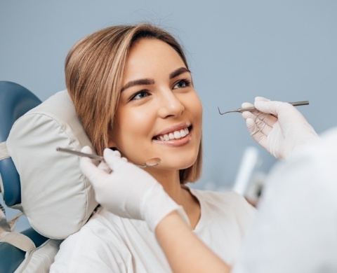 Woman smiling at her dentist during a dental checkup