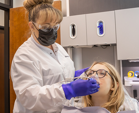 Dental patient having their mouth scanned with an intraoral camera