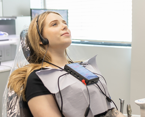 Dental patient wearing headphones