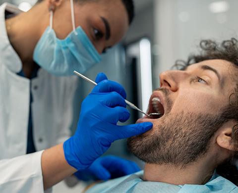 Dental patient having his teeth examined