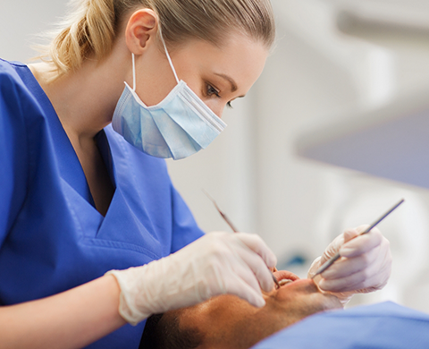 Dental patient having their mouth examined