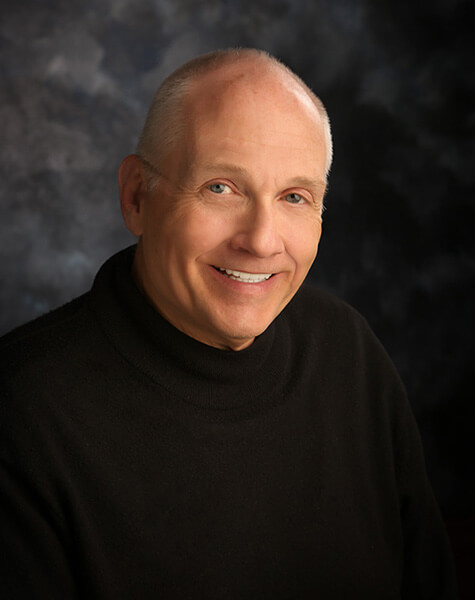 Smiling man in black sweater