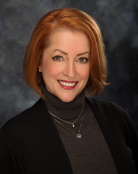 Woman with short red hair grinning