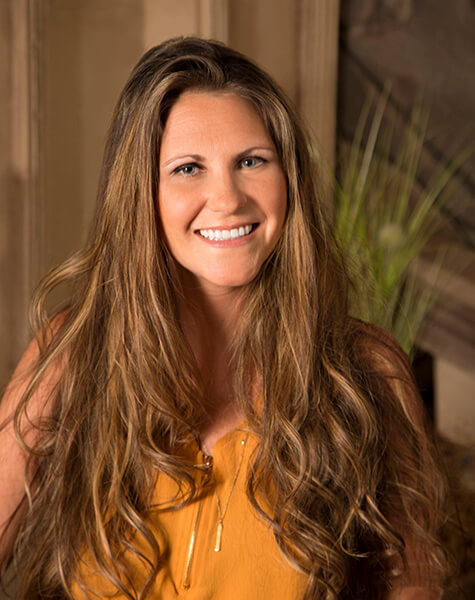 Smiling woman with long dirty blonde hair