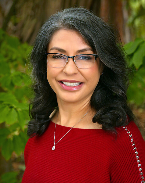 Woman in red sweater smiling outdoors