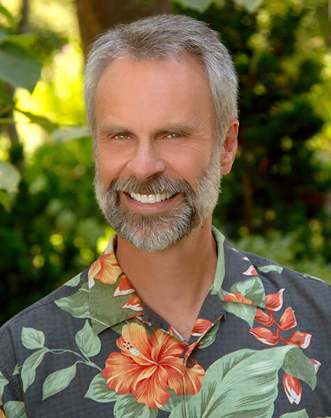 Smiling older man in floral print shirt