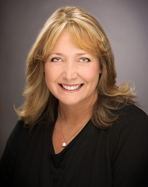 Smiling blonde woman in black blouse