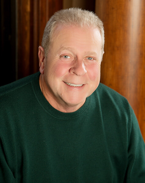 Smiling senior man in green sweater