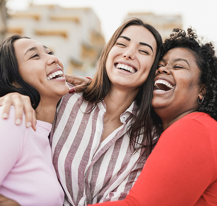 Three women laughing together after T M J treatment in Eugene