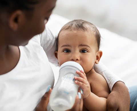 Baby drinking milk from a bottle